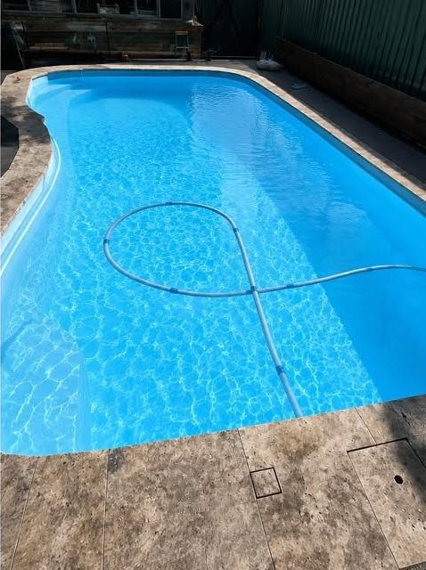 The same pool with clear blue water after treatment